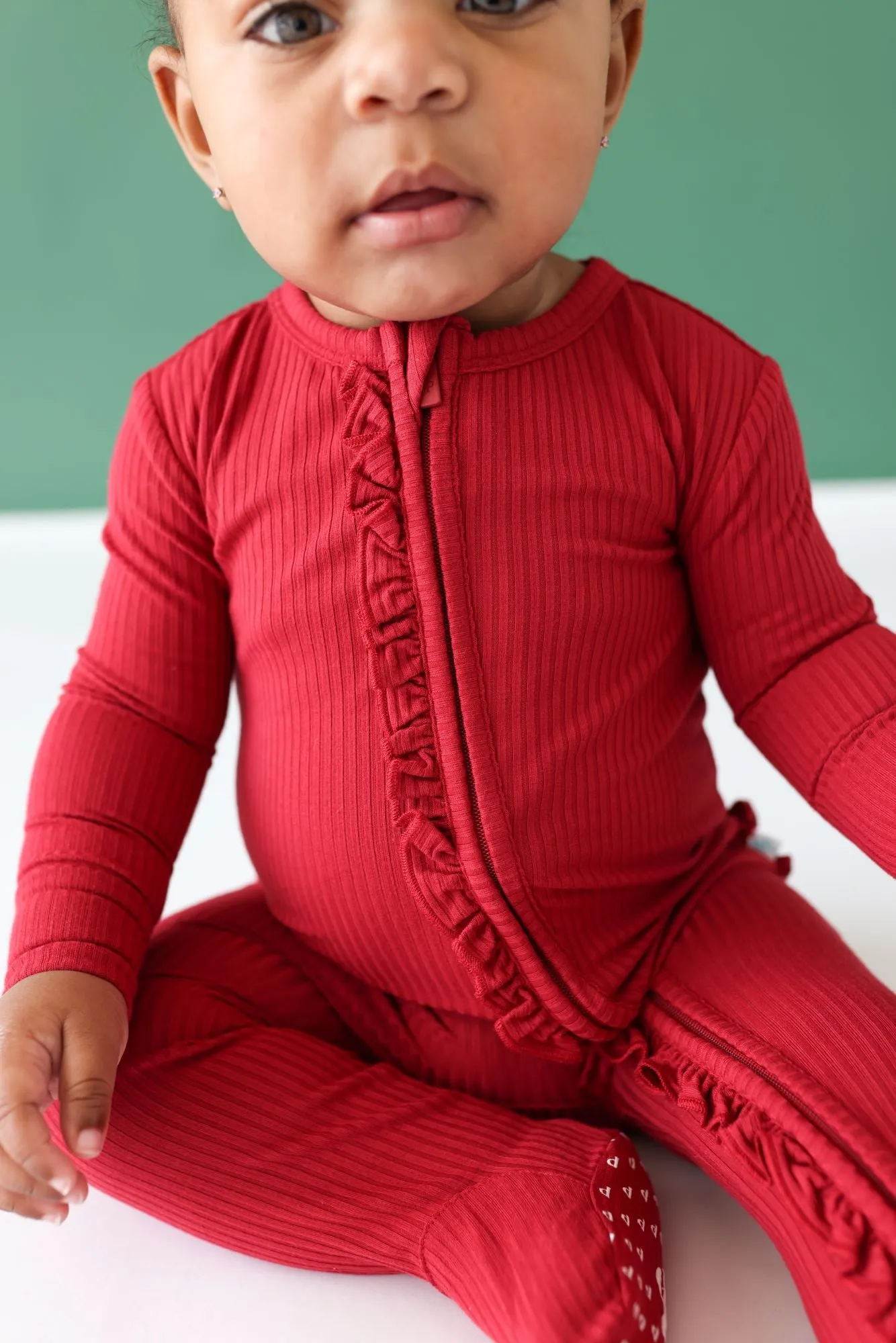 Posh Peanut Dark Red Solid Ribbed Ruffled Zippered Footie